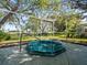 A screened-in hot tub with a handrail offers backyard views and relaxation at 9355 French Quarters Cir, Weeki Wachee, FL 34613