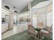 Open kitchen and breakfast nook with white cabinets and ample natural lighting at 9355 French Quarters Cir, Weeki Wachee, FL 34613