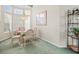 Cozy breakfast nook with glass table, bright windows, and comfortable seating at 9355 French Quarters Cir, Weeki Wachee, FL 34613