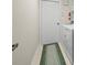 Functional laundry room with a washer, dryer, and space-saving storage solutions at 9355 French Quarters Cir, Weeki Wachee, FL 34613
