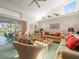 Bright living room with a view of the screened-in patio and cozy seating arrangements at 9355 French Quarters Cir, Weeki Wachee, FL 34613