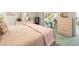 Tranquil main bedroom with light pink accents, soft carpet and a large dresser with mirror at 9355 French Quarters Cir, Weeki Wachee, FL 34613