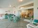 A screened-in patio with a bar and wicker dining set, offers access to the living room at 9355 French Quarters Cir, Weeki Wachee, FL 34613