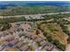 Aerial view of homes in community near wooded area and highway at 10106 Tolman Dr, Hudson, FL 34667