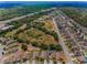 Aerial view of a community with tree coverage and a highway nearby at 10106 Tolman Dr, Hudson, FL 34667