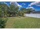 Expansive fenced backyard with lush grass and privacy landscaping at 10106 Tolman Dr, Hudson, FL 34667