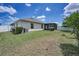 The rear of the property boasts a large lawn, screened lanai, and mature landscaping, ideal for outdoor activities at 10106 Tolman Dr, Hudson, FL 34667