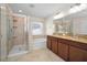 Modern bathroom featuring a glass shower, a soaking tub, and double sinks with granite countertops at 10106 Tolman Dr, Hudson, FL 34667