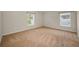 Neutral bedroom with carpet, two windows, and ample natural light creating a cozy atmosphere at 10106 Tolman Dr, Hudson, FL 34667
