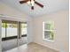 Bright bedroom with tile floors opens to the patio with sliding glass door and window at 10106 Tolman Dr, Hudson, FL 34667