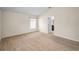Cozy bedroom featuring plush carpeting, a window with blinds, and an open doorway to the en-suite bathroom at 10106 Tolman Dr, Hudson, FL 34667