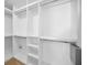 Walk-in closet with built-in shelving and hanging rods for organized storage at 10106 Tolman Dr, Hudson, FL 34667