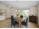 Bright dining room features a modern light fixture, neutral walls, and wood-look tile flooring at 10106 Tolman Dr, Hudson, FL 34667
