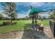 Dog park with shade canopy, bench, and grassy area for pets to enjoy at 10106 Tolman Dr, Hudson, FL 34667