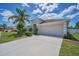 Well-maintained single-story home featuring an attached two-car garage and a neatly kept lawn and landscaping at 10106 Tolman Dr, Hudson, FL 34667