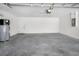 Spacious two-car garage with sealed concrete floor, water heater, and automatic door opener at 10106 Tolman Dr, Hudson, FL 34667