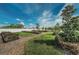 Community garden featuring garden beds with an adjacent walking path and green space at 10106 Tolman Dr, Hudson, FL 34667