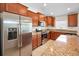 Kitchen with stainless steel appliances, granite countertops, and maple cabinets at 10106 Tolman Dr, Hudson, FL 34667