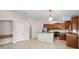 Bright kitchen features stainless appliances, wooden cabinetry, and granite counters with a built-in desk at 10106 Tolman Dr, Hudson, FL 34667