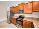 Modern kitchen featuring stainless steel appliances, granite countertops, and ample cabinet space at 10106 Tolman Dr, Hudson, FL 34667