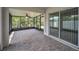 Enjoy outdoor living on this large screened lanai with brick pavers and a ceiling fan at 10106 Tolman Dr, Hudson, FL 34667