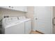 Functional laundry room equipped with a washer, dryer, and ample storage cabinets at 10106 Tolman Dr, Hudson, FL 34667