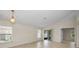 Bright, neutral living area featuring tile flooring, large windows, and sliding glass doors to a covered patio at 10106 Tolman Dr, Hudson, FL 34667