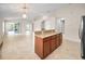 Open-concept living space features tile floors, high ceilings, and a granite-topped kitchen counter bar at 10106 Tolman Dr, Hudson, FL 34667