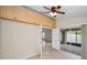 Versatile room with ceiling fan, built-in storage cabinets, and sliding door access to a screened patio at 10106 Tolman Dr, Hudson, FL 34667