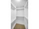 A walk-in closet with multiple shelves, rods, and carpeted floor offers abundant storage space at 10106 Tolman Dr, Hudson, FL 34667