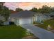 An aerial view showcasing a single-story home with manicured lawn and extended driveway at 10235 Skyland St, Spring Hill, FL 34608