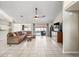 Spacious living room with tile flooring, a ceiling fan, and a view of the pool at 10235 Skyland St, Spring Hill, FL 34608