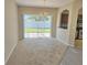 Open dining area featuring sliding doors to the backyard, carpet, and a decorative chandelier at 10238 Perthshire Cir, Land O Lakes, FL 34638