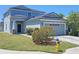Charming two-story home featuring a well-manicured lawn, a two-car garage, and attractive landscaping at 10238 Perthshire Cir, Land O Lakes, FL 34638