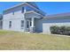 View of the home's facade showcasing the lawn, columns, and a glimpse of the roofline at 10238 Perthshire Cir, Land O Lakes, FL 34638
