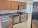 Functional kitchen with wooden cabinets, stainless steel appliances, and durable countertops at 10238 Perthshire Cir, Land O Lakes, FL 34638