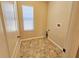 Laundry room with tile floors and a window at 10238 Perthshire Cir, Land O Lakes, FL 34638