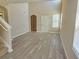 Inviting living room with natural light, laminate flooring, and staircase access at 10238 Perthshire Cir, Land O Lakes, FL 34638
