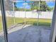 Covered patio overlooking a grassy yard and white fence offering privacy at 10238 Perthshire Cir, Land O Lakes, FL 34638