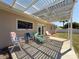 View of the backyard with a shaded pergola patio and lawn furniture at 10478 Laval St, Spring Hill, FL 34608