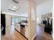Open kitchen with stainless steel appliances and wood countertops leads to the living room and stone fireplace at 10478 Laval St, Spring Hill, FL 34608