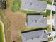 Aerial view of rooftops of homes adjacent to a community pond at 10823 Penny Gale Loop, San Antonio, FL 33576