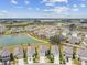 Aerial view of a residential neighborhood and ponds on a sunny day at 10823 Penny Gale Loop, San Antonio, FL 33576