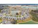Aerial view of a neighborhood featuring a central lake with community amenities at 10823 Penny Gale Loop, San Antonio, FL 33576