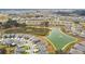 Wide aerial view showcasing a Primary-planned community, including a central pond with a fountain and modern single-Gathering homes at 10823 Penny Gale Loop, San Antonio, FL 33576