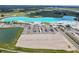 Aerial view of a community lagoon, showing beach, parking, and surrounding areas at 10823 Penny Gale Loop, San Antonio, FL 33576
