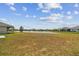 Expansive backyard with a serene lake view and lush greenery at 10823 Penny Gale Loop, San Antonio, FL 33576