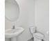 Clean bathroom features a pedestal sink and toilet, perfect for guests at 10823 Penny Gale Loop, San Antonio, FL 33576