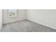 Cozy bedroom with a window providing natural light and neutral carpeting at 10823 Penny Gale Loop, San Antonio, FL 33576