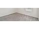 Bedroom featuring soft carpet, neutral walls, and a window providing natural light at 10823 Penny Gale Loop, San Antonio, FL 33576